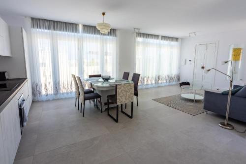a dining room with a table and chairs in a room at Penthouse Cathedral and Seaview Terrace V2 in Valletta