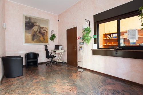 an office with a desk and chairs in a room at Residence Lepontina in Milan
