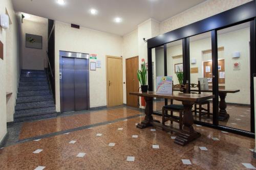 a hallway with a desk and a door in a building at Residence Lepontina in Milan