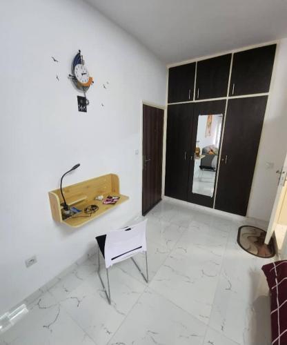 a white room with a table and a chair at Over cloud 1 in Marcory
