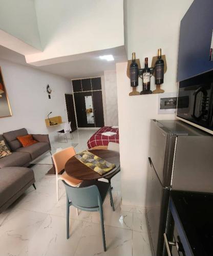 a kitchen and living room with a couch and a table at Over cloud 1 in Marcory