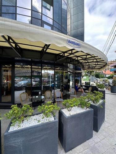 a restaurant with tables and chairs in front of a building at Business class studio with the Mountain View 115А in Batumi