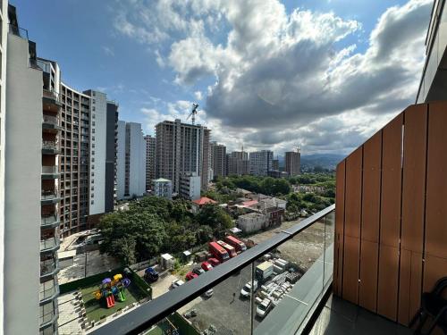 a view of a city from the balcony of a building at Business class studio with the Mountain View 115А in Batumi