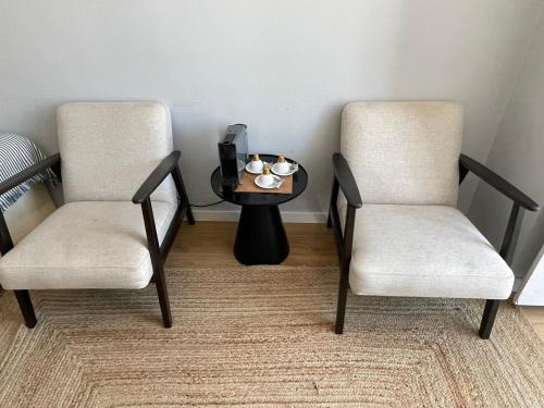 two chairs and a coffee table in a room at Lisbon Check-In Guesthouse in Lisbon
