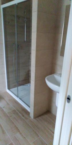 a bathroom with a shower and a toilet and a sink at Camping Il Vecchio Mulino in Opi