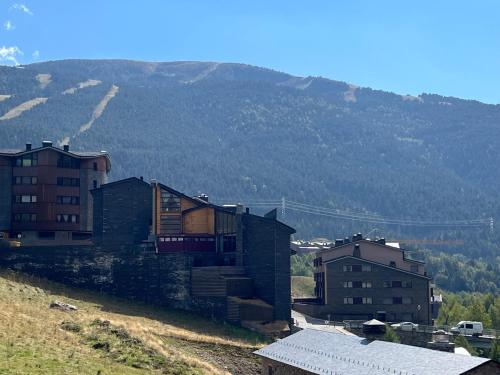 a group of buildings sitting on top of a hill at Wuau! Hotel Galanthus & Spa in Soldeu