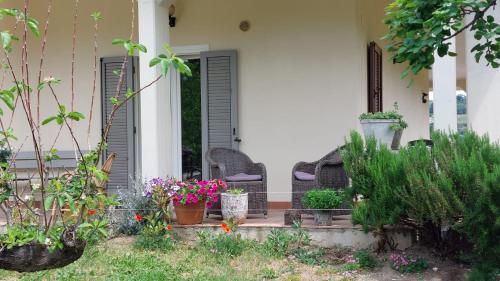 a porch of a house with flowers and plants at Villa Vista Monti in Bolognano