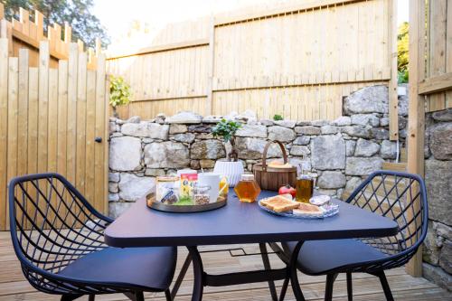 a blue table with food and drinks on a patio at as Alvarizas in Moraña