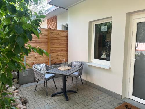 a table and two chairs on a patio at Bungalow Blue Sky in Benz