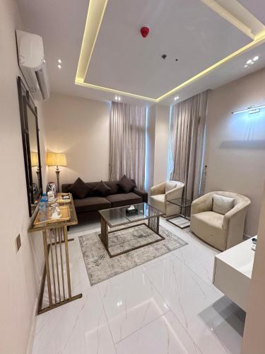 a living room with a couch and a table at Pavilion Suites - Premium ApartHotel in Bahria Town in Rawalpindi