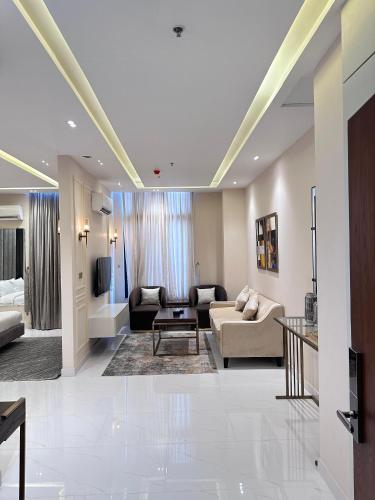a living room with a couch and a table at Pavilion Suites - Premium ApartHotel in Bahria Town in Rawalpindi