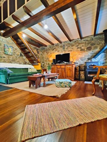 a living room with a stone wall at Azoka by the River- Proença-a-Nova in Maljoga de Proença