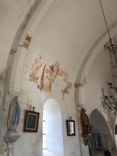 a church with paintings on the wall and a niche at La Clé Des Champs in Villiers-les-Hauts