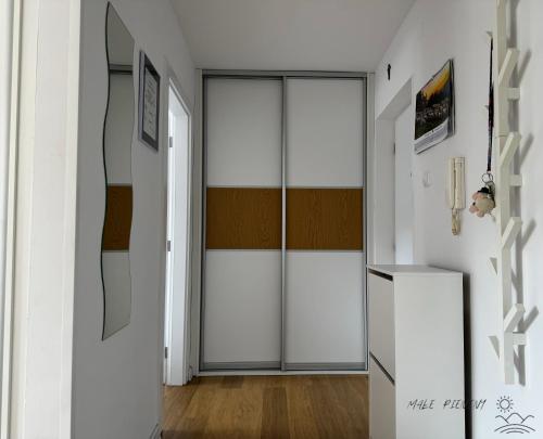 a hallway with a sliding glass door in a room at Małe Pieniny in Szczawnica