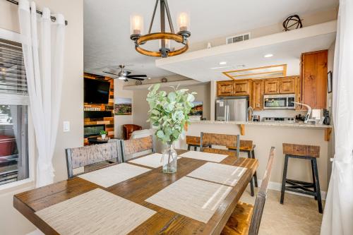 a kitchen and dining room with a wooden table and chairs at Mesquite Apartment Walk to Wolf Creek Golf Club! in Mesquite