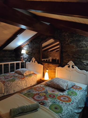 a bedroom with two beds and a mirror at Azoka by the River- Proença-a-Nova in Maljoga de Proença