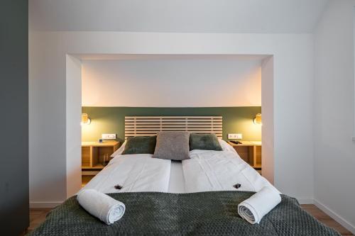 a bedroom with a large bed with two pillows at Balatonic Lime apartmanház in Siófok