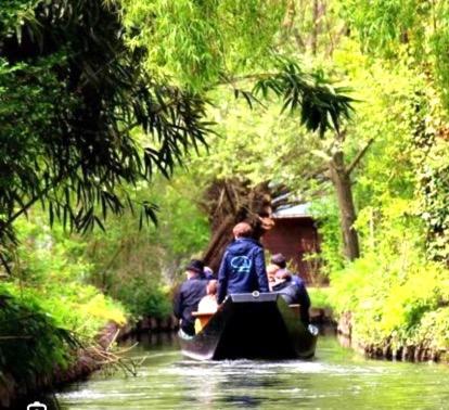 a group of people riding in a boat on a river at Le petit coin de la Haute Somme in Hem-Monacu
