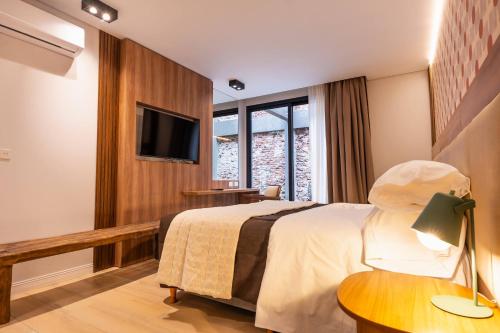 a hotel room with a bed and a television at Nuit Hotel in Mar del Plata
