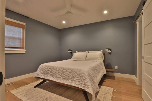 a bedroom with a bed with a white bedspread at Spacious 3B2B Minutes to Skyline in Waynesboro
