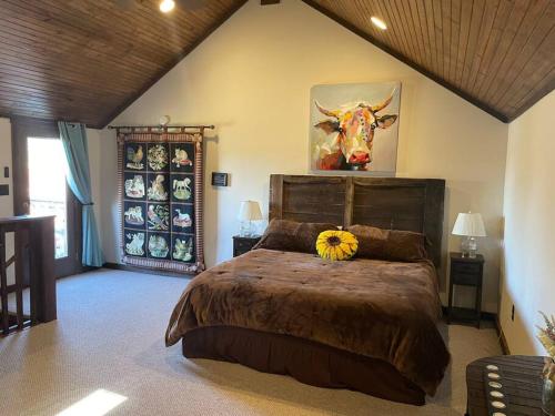 a bedroom with a bed with a cow on the wall at Pleasant Valley Farm Dairy Barn writer's retreat in Columbia