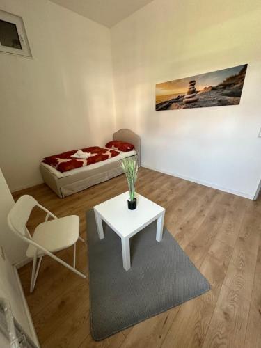 a room with a bed and a table and a chair at Appartement for Rent 03 in Pattensen