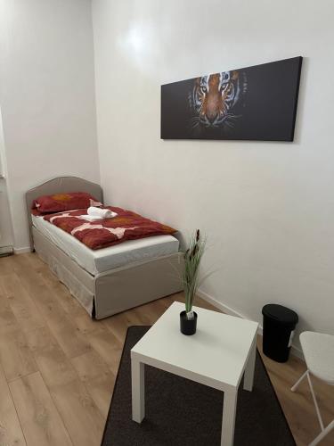 a bedroom with a bed and a white table at Appartement for Rent 03 in Pattensen