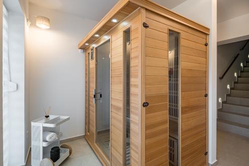 a pivot door in a bathroom with a staircase at Balatonic Lime apartmanház in Siófok