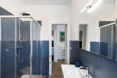 a bathroom with a glass shower and a sink at Il Borgo Incantato con garage in Finale Ligure