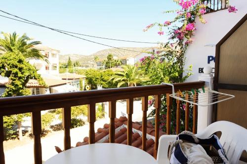 a balcony with a table and a view of a street at Potokaki Beachfront Hotel in Pythagoreio