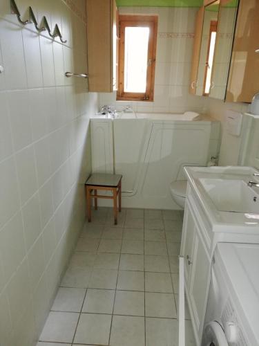 a bathroom with a tub and a toilet and a sink at Sommerferienhaus Jeannette in Strausberg