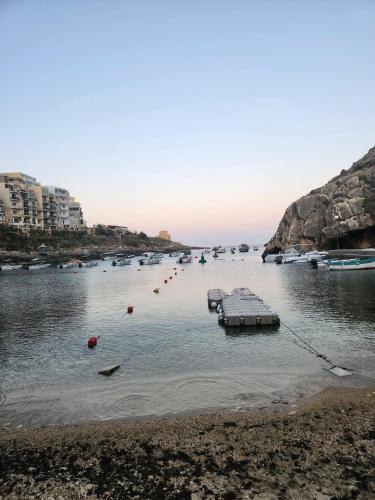 a body of water with boats in it at Penelope Apartments 15 in Xlendi