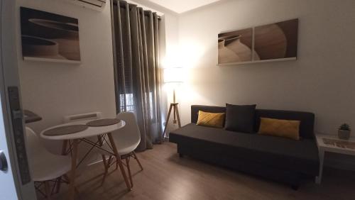 a living room with a couch and a table at AT Marem II in Cáceres