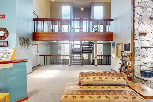 a living room with two beds and a staircase at Buffalo Village 402 in Silverthorne