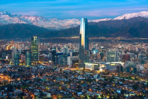 an aerial view of a city at night with mountains at hostal andino in Santiago