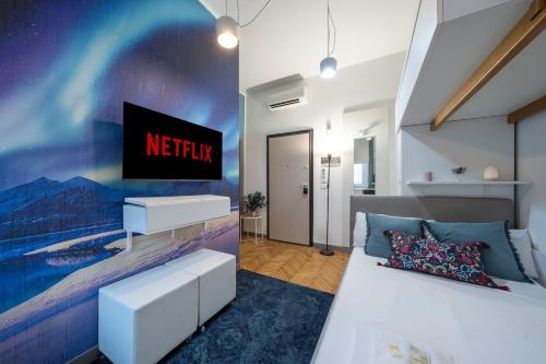 a bedroom with a bed and a tv on a wall at Loreto Prestige - Parking Free & Bulb Gym in Milan