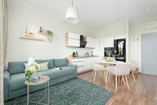 a living room with a blue couch and a table at TS Boutique Apartments in Szczecin