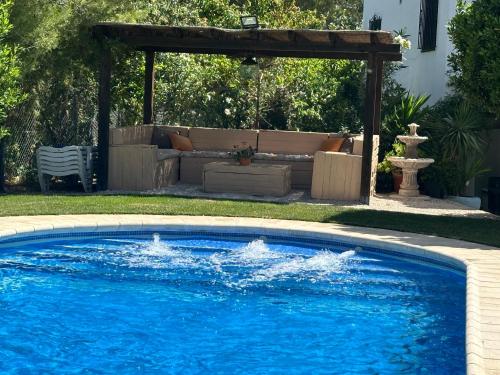 a swimming pool in a yard with a pergola at La Casa De La Abuela in Setenil