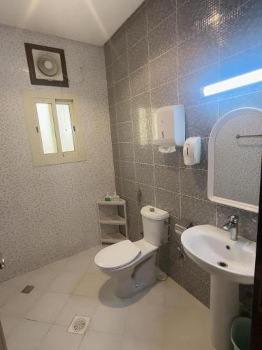 a bathroom with a toilet and a sink at Luxury apartment with balcony, City view in Jeddah