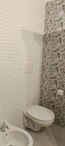 a bathroom with a toilet and a shower curtain at Panorama City in Conversano
