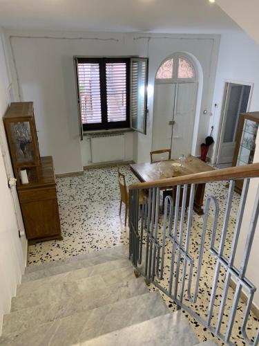 a room with a staircase and a table and a window at Bed & Breakfast StudioArcodia- in San Marco dʼAlunzio