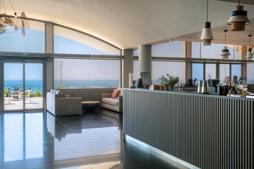 a lobby with a view of the ocean at Mangia's Torre Del Barone Resort & SPA in Sciacca