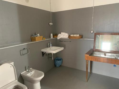 a bathroom with a toilet and a sink at Bed & Breakfast StudioArcodia- in San Marco dʼAlunzio