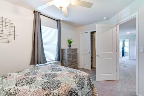a bedroom with a bed and a ceiling fan at Wesley Chapel End Unit with Patio and Nature Views! in Wesley Chapel