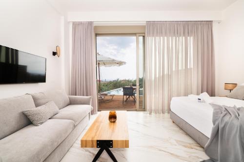 a living room with a couch and a table at Petradi Suites in Kalamata