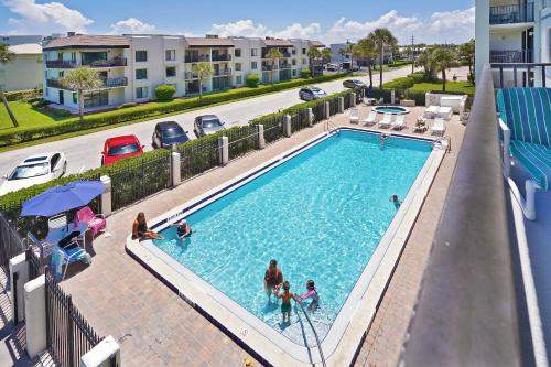 an overhead view of a swimming pool at a apartment complex at Cape Winds Resort in Cape Canaveral