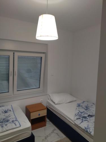 Ένα ή περισσότερα κρεβάτια σε δωμάτιο στο Nediljka Ramljak apartman