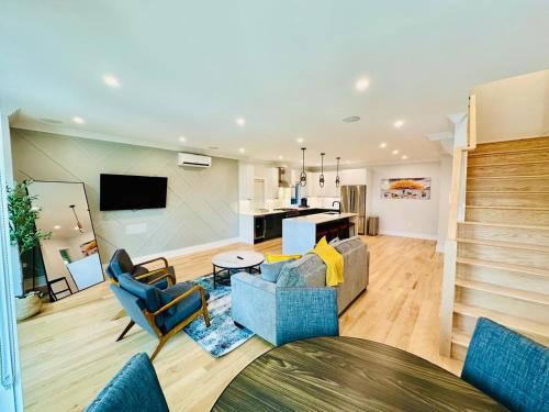 a living room with a couch and chairs at Huge 2000 sqft Luxury & Stylish Condo minutes to New York in Jersey City