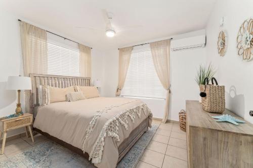 a bedroom with a large bed and a window at Sandy Beach Villa - Spectacular setting on the beach (full service generator) in Rincon