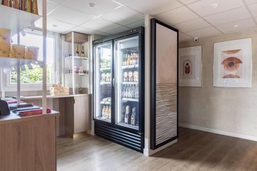 a room with a refrigerator with drinks in it at Brit Hotel Angers Parc Expo - L'Acropole in Saint-Sylvain-dʼAnjou
